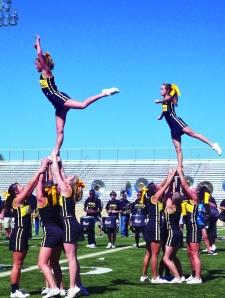Cheer team practices stunt at recent pep rally